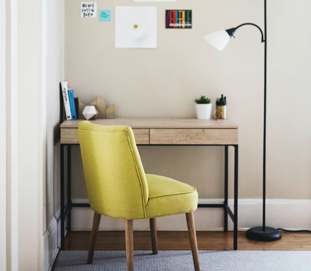 Clean, simple arts and crafts desk placed in the corner of a living room