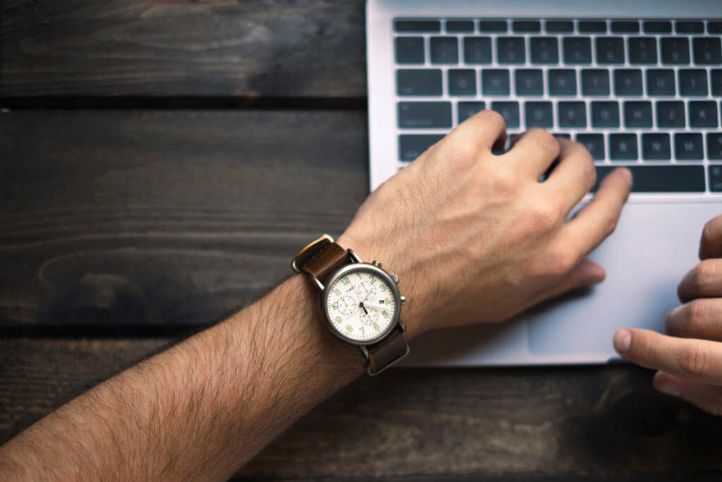 Checking the time while working on a laptop