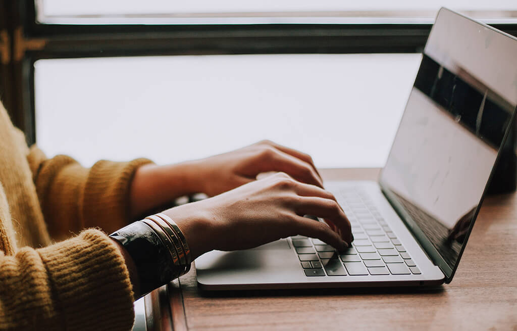 Woman typing on laptop